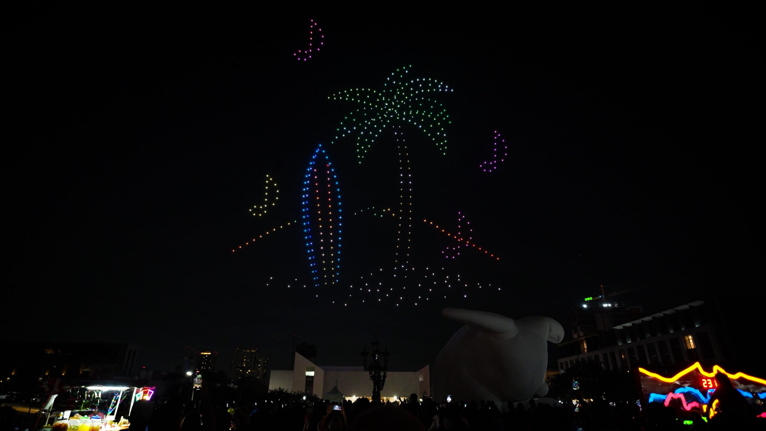Lumasky light show at the Santa Lucía Festival in Monterrey, where 500 drones create a tropical composition in the sky with a palm tree, surfboard and bright butterflies.