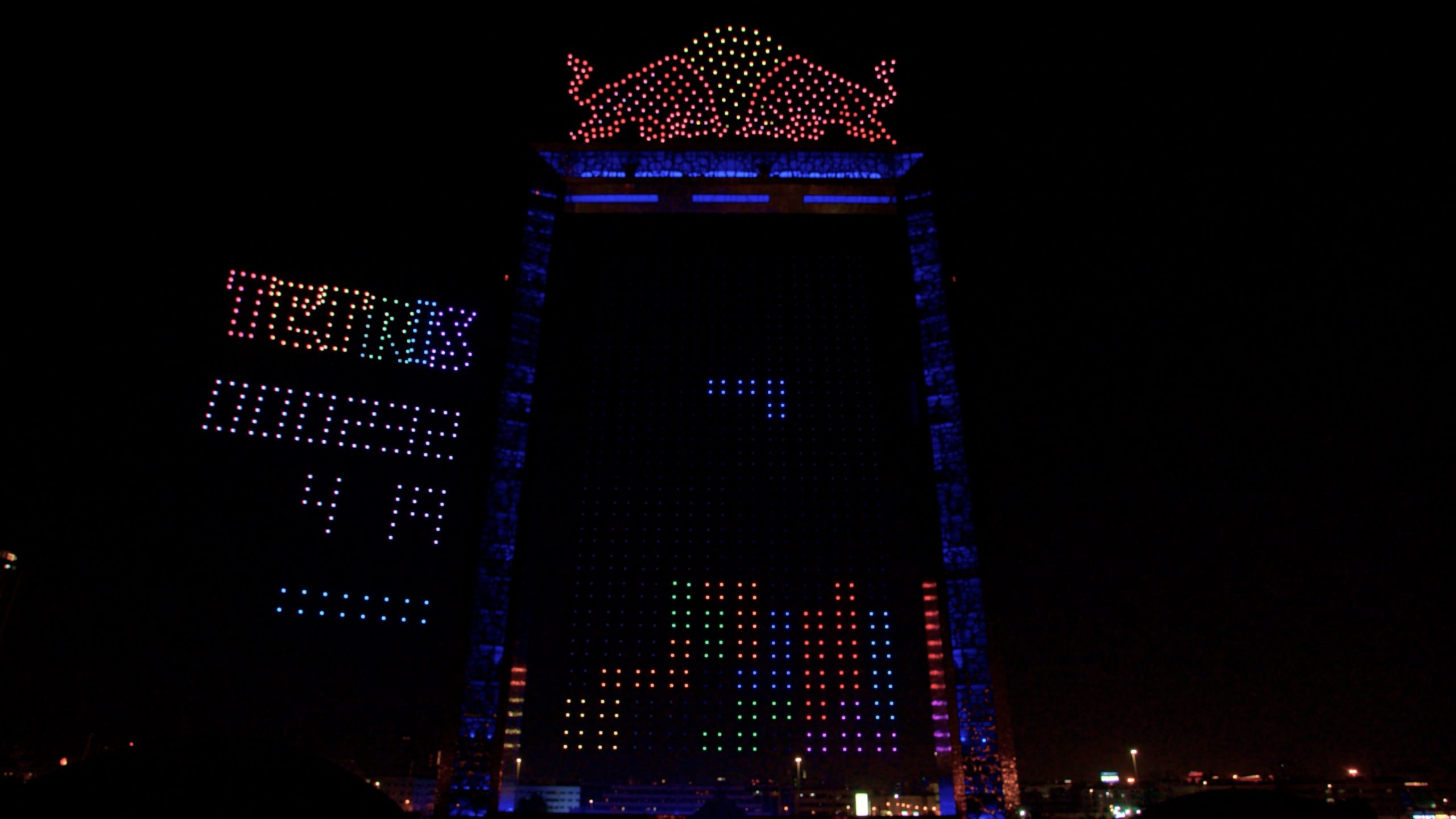During the Red Bull Tetris Final in Dubai, the facade of a high-rise building was transformed into a giant Tetris screen with bright pixel shapes and the Red Bull logo, as part of the 4,000 Lumasky Drone Show.